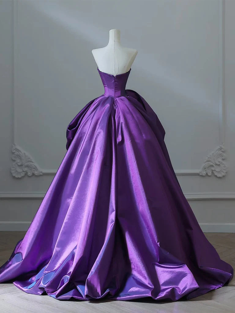 Back view of a model in a purple satin formal gown.