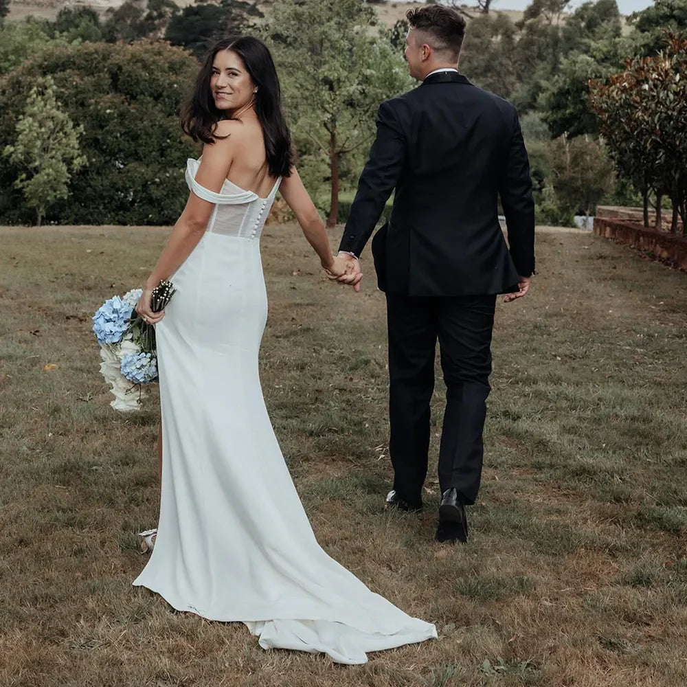 Side view of the elegant one-shoulder mermaid wedding dress, highlighting the silhouette.
