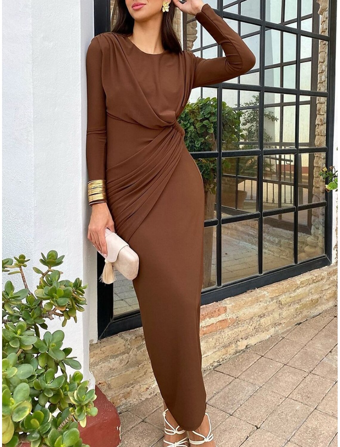 Woman in a brown long sleeve bodycon maxi dress, showing the back detail.