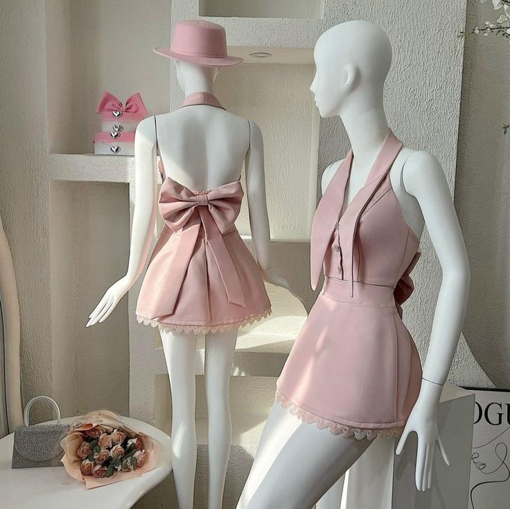 Model wearing a light two-piece satin and lace short homecoming dress with a bow.