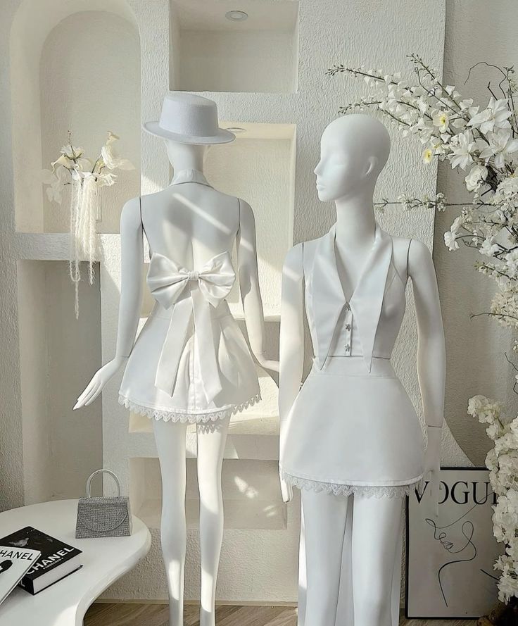 Back view of a model in a two-piece satin and lace short homecoming dress, highlighting the bow.