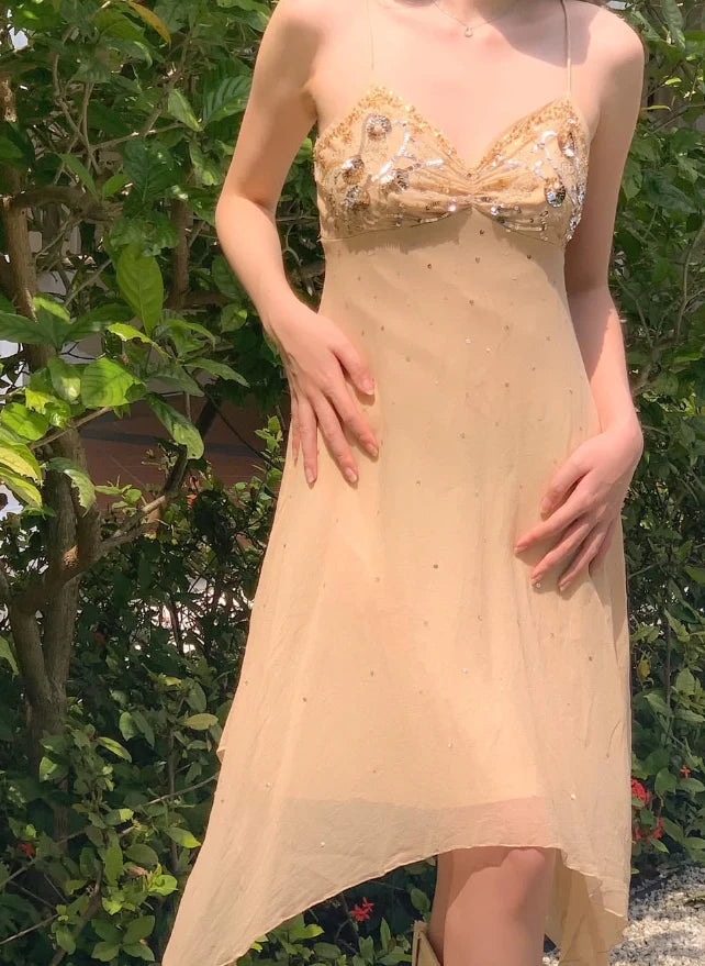 Woman posing in a light blue A-line homecoming dress with spaghetti straps and beading.