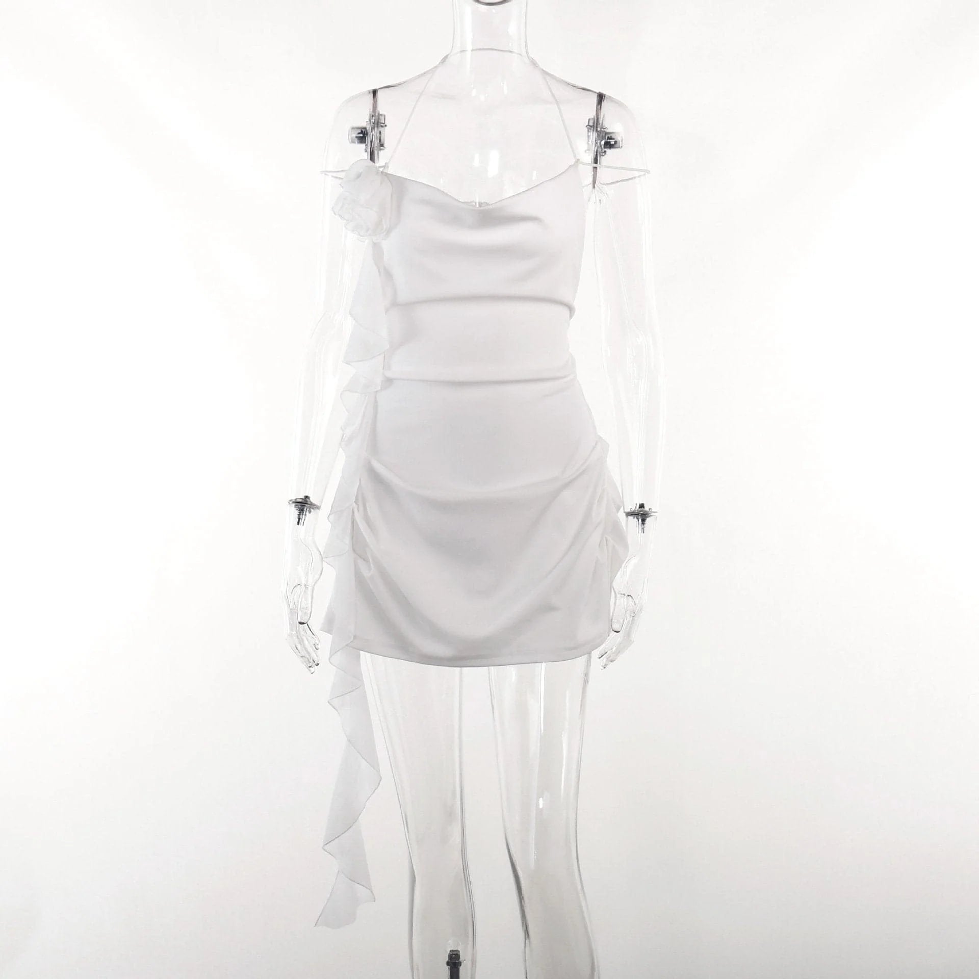 Close-up of the floral applique and ruched detail on the side of the white mini dress.