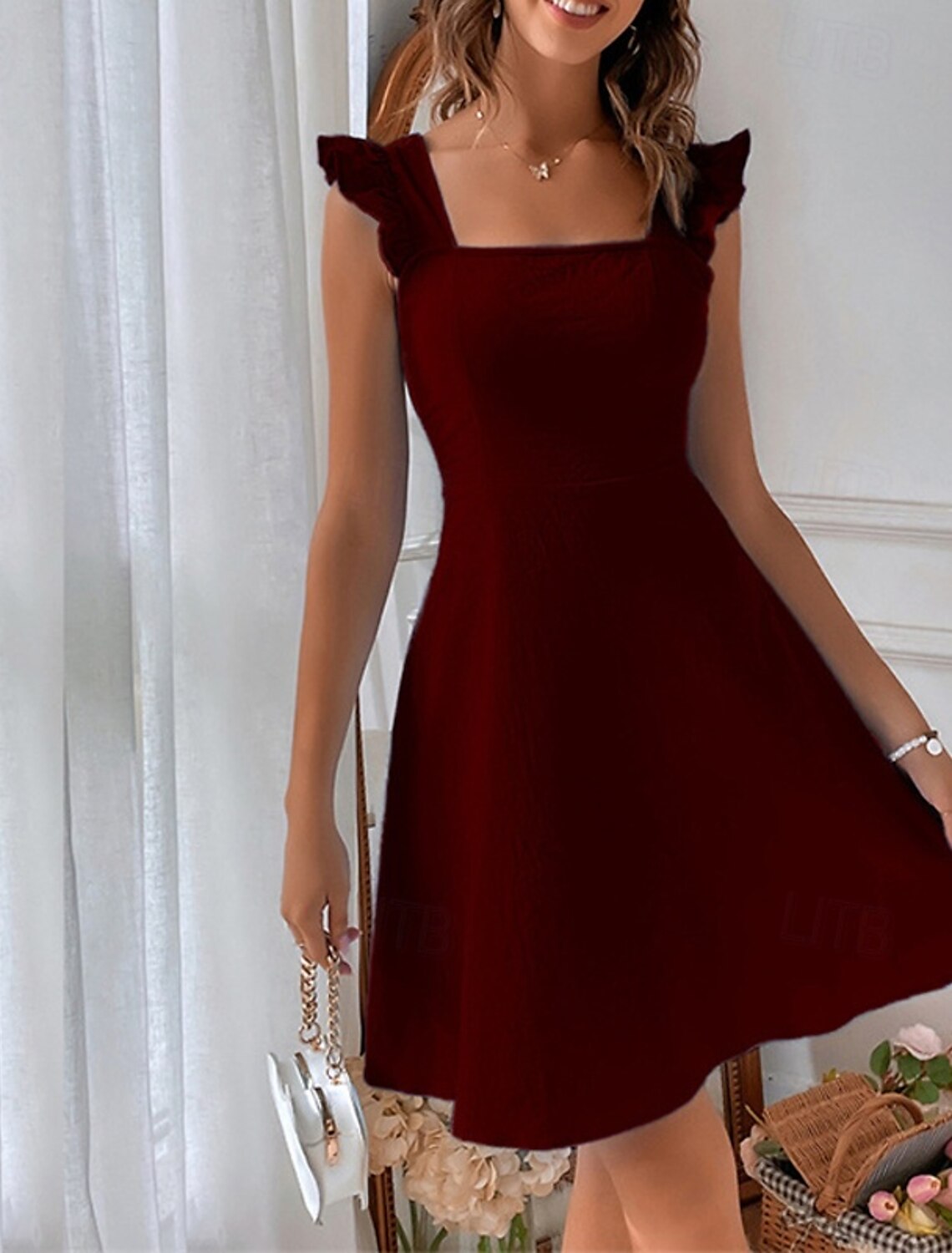 Woman smiling, showcasing the versatile plain mini dress with butterfly sleeves.